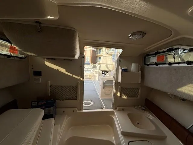 Slide: The Image of Interior view of 2018 Grady-White 228 Seafarer boat cabin, featuring seating and storage. - 13