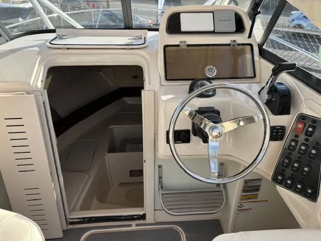 Slide: The Image of 2018 Grady-White 228 Seafarer boat interior with steering wheel and cabin entrance. - 18