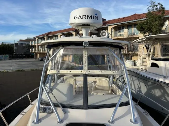 Slide: The Image of 2018 Grady-White 228 Seafarer boat with Garmin radar, docked near residential buildings. - 21