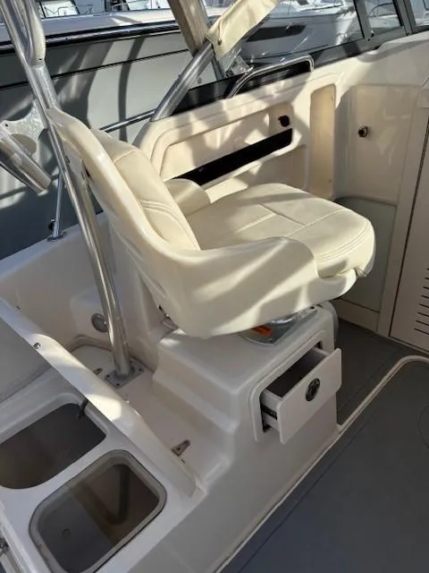 Slide: The Image of 2018 Grady-White 228 Seafarer boat interior with white seating and storage compartments. - 24
