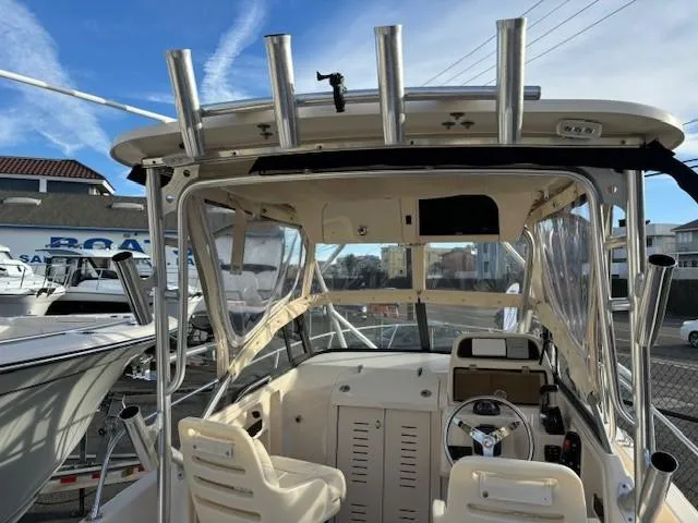 Slide: The Image of 2018 Grady-White 228 Seafarer boat interior with steering wheel and rod holders. - 37