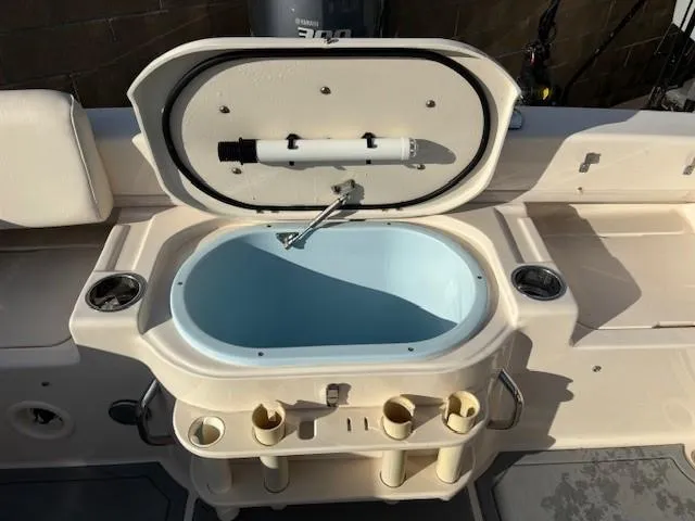 Slide: The Image of 2018 Grady-White 228 SEAFARER boat livewell with open lid and rod holders. - 42
