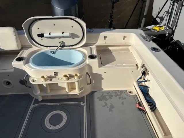 Slide: The Image of 2018 Grady-White 228 Seafarer boat deck with open storage and fishing equipment. - 43