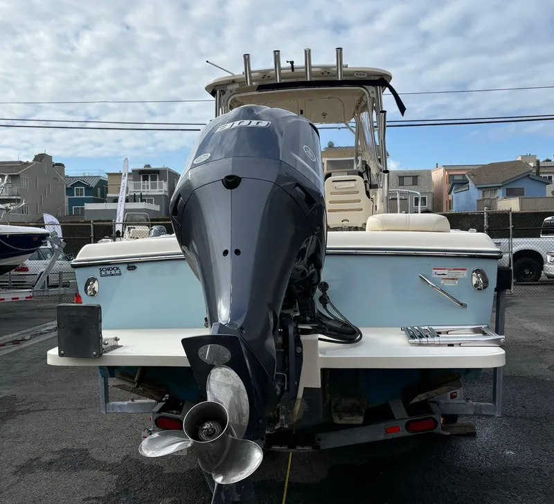 Slide: The Image of 2018 Grady-White 228 Seafarer boat with outboard motor, docked in a marina. - 46