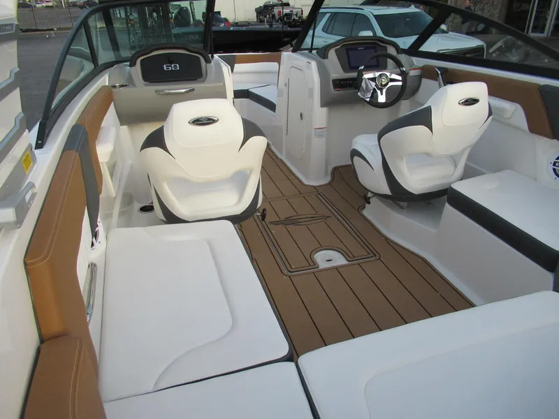 Slide: The Image of 2025 Chaparral 23 SSI SPORT boat interior with modern seating and dashboard design. - 2