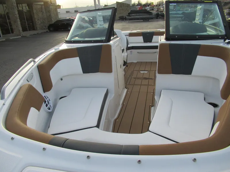 Slide: The Image of 2025 Chaparral 23 SSI SPORT boat interior with cushioned seating and wood flooring. - 3