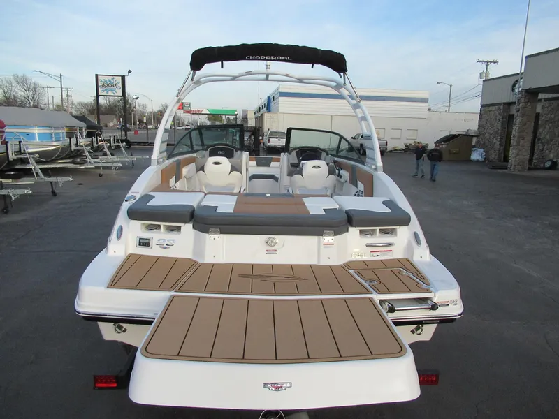 Slide: The Image of 2025 Chaparral 23 SSI SPORT boat, rear view, showcasing spacious deck and seating. - 4