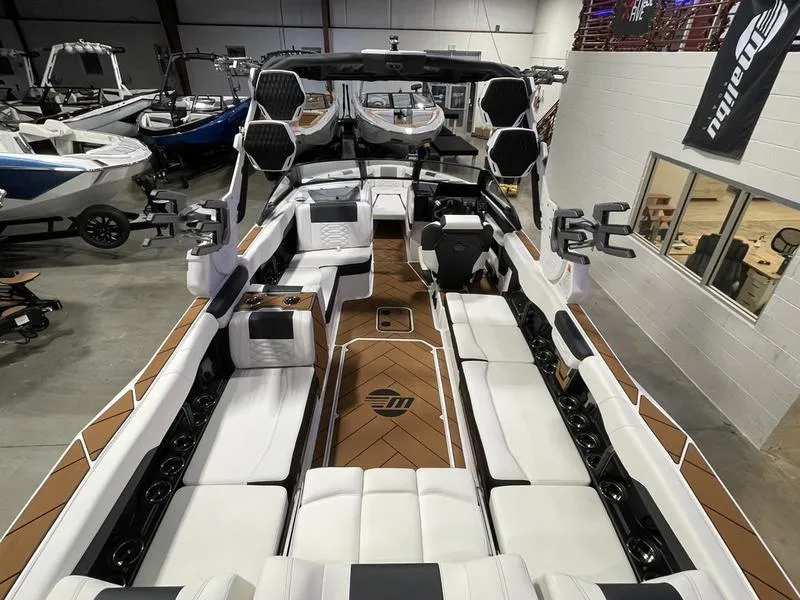 Slide: The Image of 2025 Malibu 26 LSV boat interior with luxurious seating and modern design. - 13