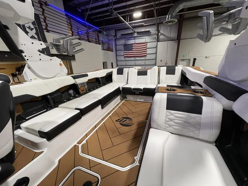 Slide: The Image of Interior of a 2025 Malibu 26 LSV boat with luxurious seating and modern design. - 15