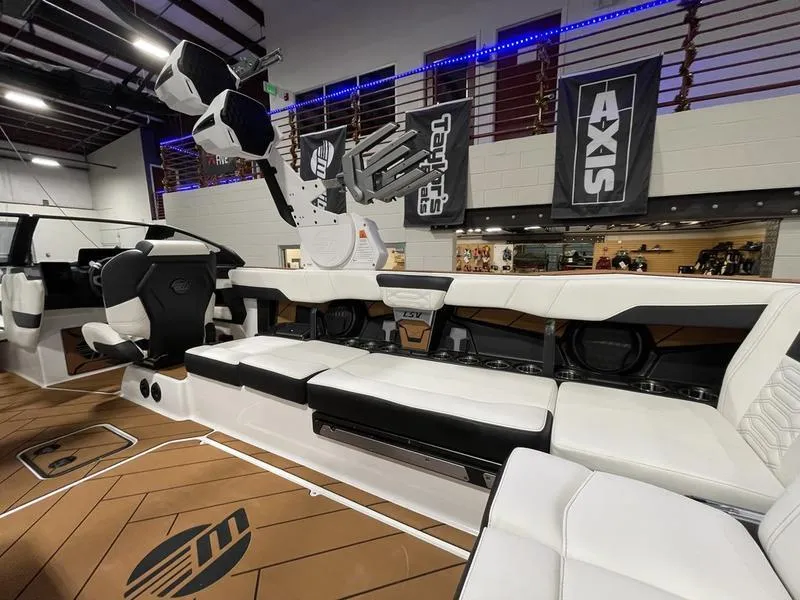 Slide: The Image of 2025 Malibu 26 LSV boat interior with white seating and modern design. - 16