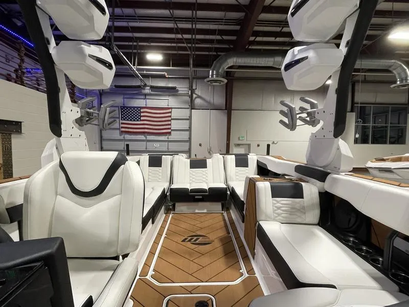 Slide: The Image of 2025 Malibu 26 LSV boat interior with luxurious white seating and modern design. - 21