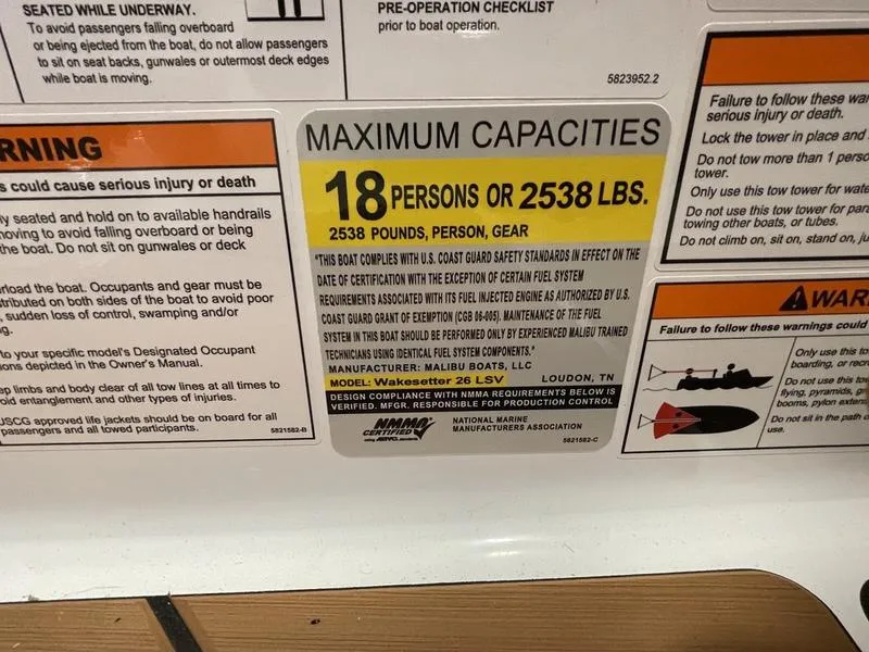 Slide: The Image of Capacity label for 2025 Malibu 26 LSV boat: 18 persons or 2538 lbs. - 22
