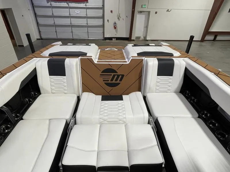Slide: The Image of 2025 Malibu 26 LSV boat interior with luxurious white and black seating. - 25