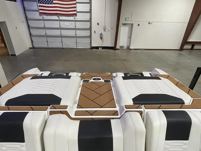 Slide: The Image of 2025 Malibu 26 LSV boat interior with sleek, modern design in a spacious garage. - 27