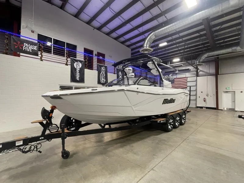 Slide: The Image of 2025 Malibu 26 LSV boat on trailer in indoor showroom. - 3