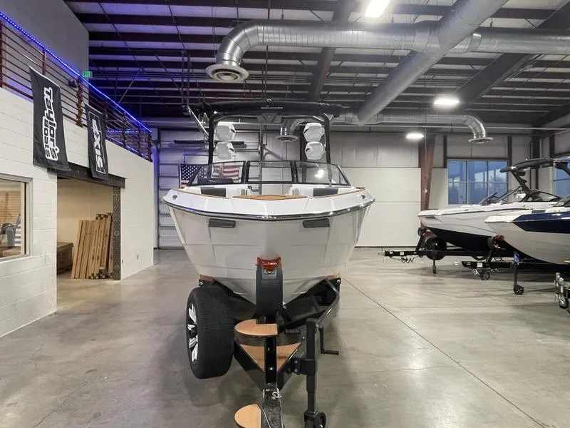 Slide: The Image of 2025 Malibu 26 LSV boat in showroom, front view, on trailer. - 4