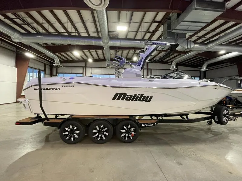 Slide: The Image of 2025 Malibu 26 LSV boat in a warehouse, side view on a trailer. - 6