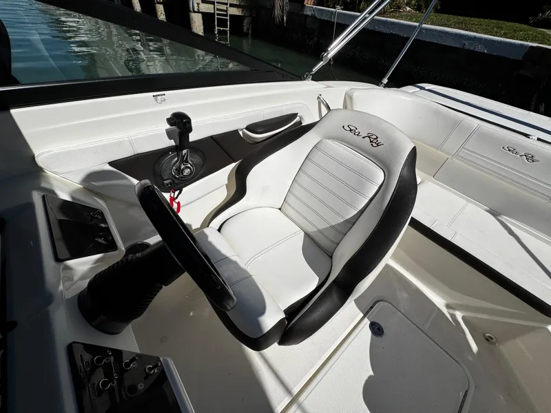Slide: The Image of 2019 Sea Ray SPX 190 OB boat interior with steering wheel and comfortable seating. - 11