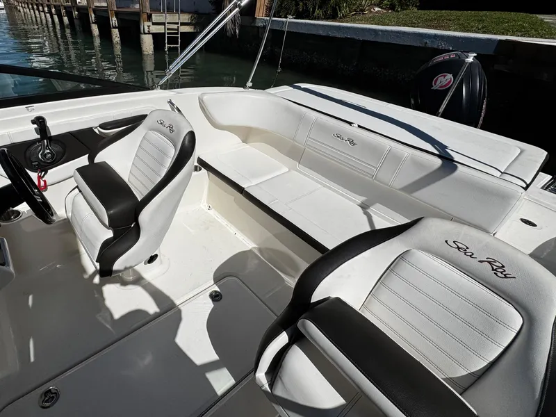Slide: The Image of 2019 Sea Ray SPX 190 OB boat interior with white seating and steering wheel. - 12