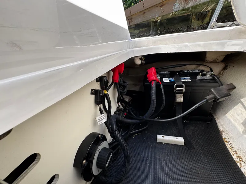 Slide: The Image of Battery compartment of a 2019 Sea Ray SPX 190 OB boat, showing wiring and connections. - 13