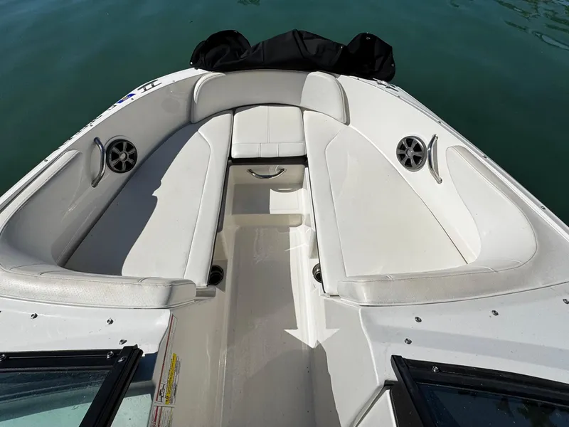 Slide: The Image of 2019 Sea Ray SPX 190 OB boat interior with white seating and speakers. - 15