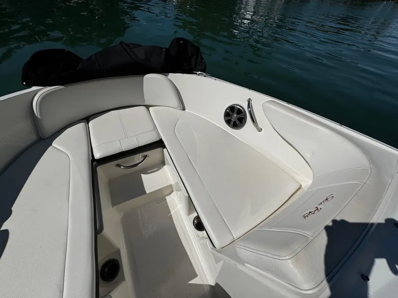 Slide: The Image of 2019 Sea Ray SPX 190 OB boat interior with white seating and speaker. - 18