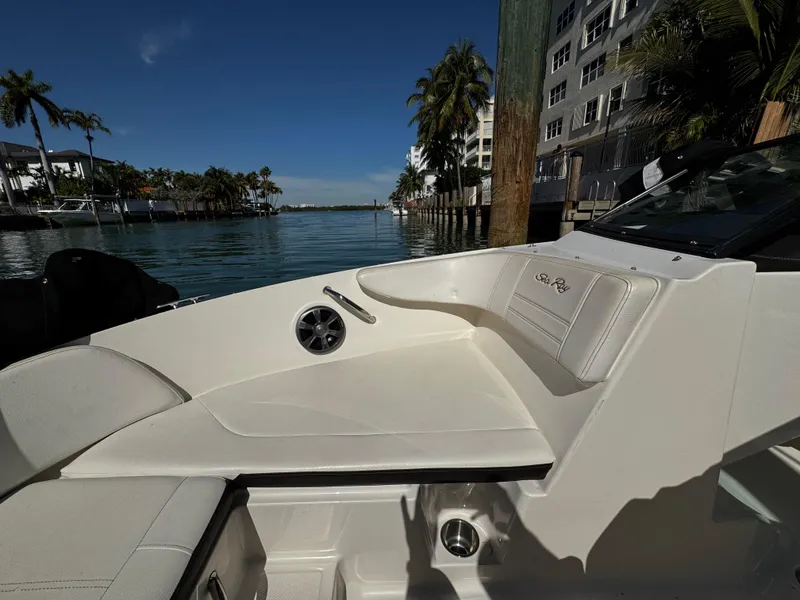 Slide: The Image of 2019 Sea Ray SPX 190 OB boat interior with waterfront view and palm trees. - 19