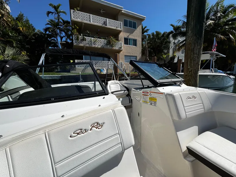 Slide: The Image of 2019 Sea Ray SPX 190 OB boat docked near a residential building. - 21