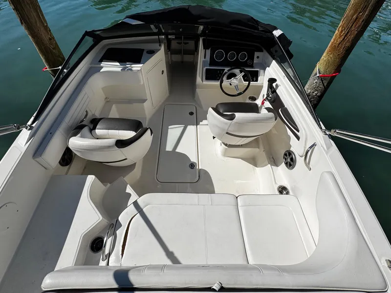 Slide: The Image of 2019 Sea Ray SPX 190 OB boat interior with white seating and steering console. - 7