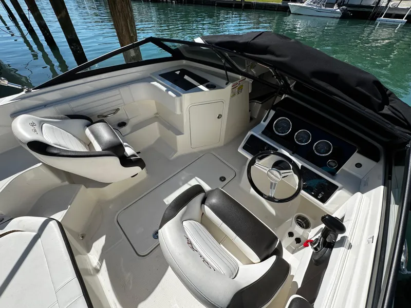 Slide: The Image of 2019 Sea Ray SPX 190 OB boat interior with steering wheel and seating. - 8