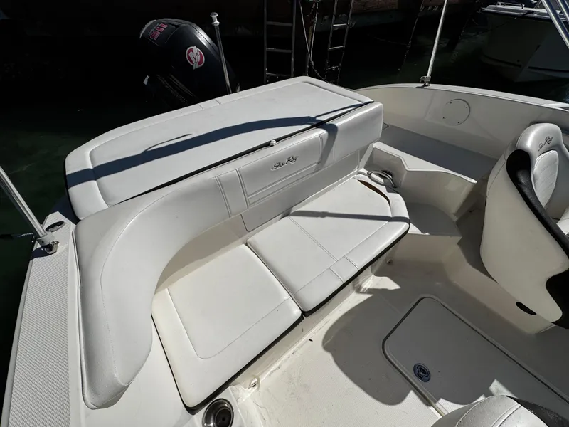 Slide: The Image of 2019 Sea Ray SPX 190 OB boat interior with white seating and outboard motor. - 9