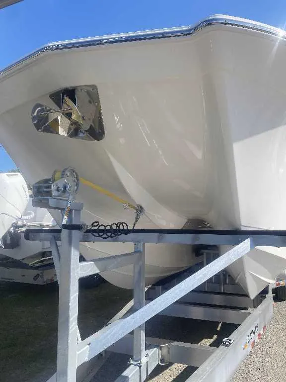 Slide: The Image of 2025 Caymas 34 CT boat on trailer under clear blue sky. - 1