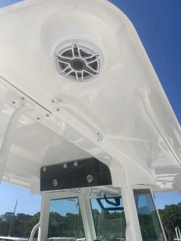 Slide: The Image of 2025 Caymas 34 CT boat roof with speaker and blue sky background. - 12