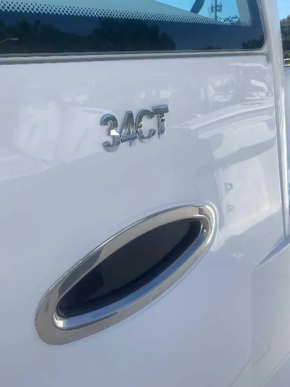 Slide: The Image of 2025 Caymas 34 CT boat exterior with model emblem and sleek design. - 14
