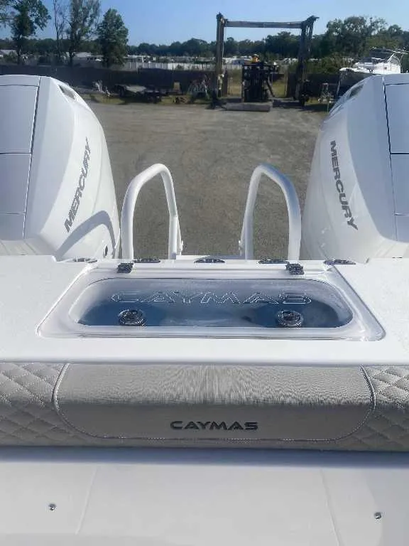 Slide: The Image of 2025 Caymas 34 CT boat with dual Mercury engines, rear view. - 15