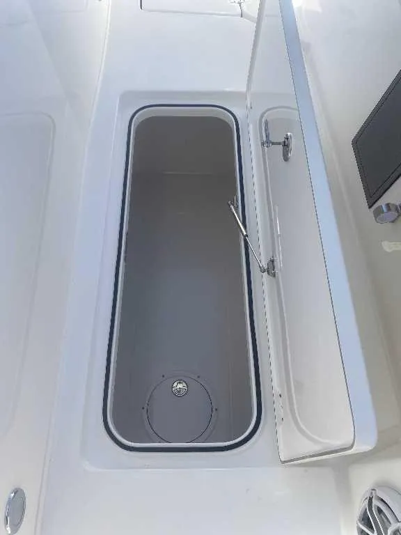 Slide: The Image of Open storage compartment on 2025 Caymas 34 CT boat, showcasing interior space. - 24