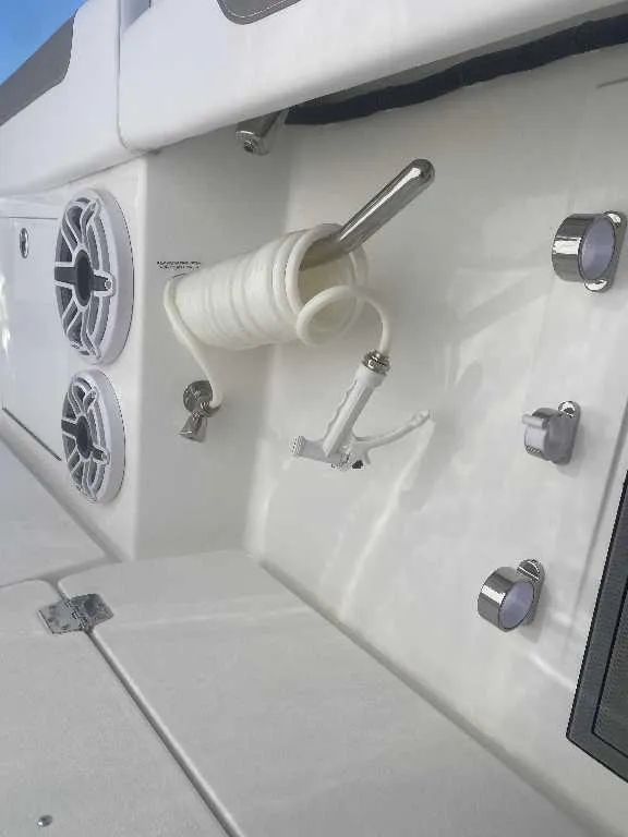 Slide: The Image of 2025 Caymas 34 CT boat deck with coiled hose and speakers. - 5