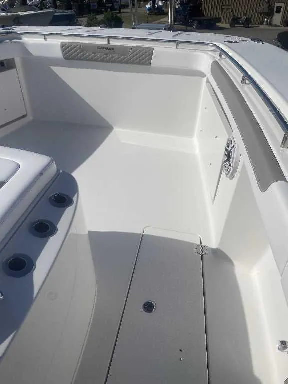 Slide: The Image of 2025 Caymas 34 CT boat interior, featuring sleek white deck and seating area. - 6