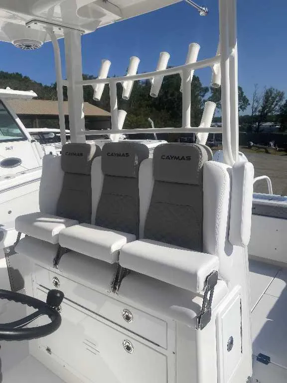 Slide: The Image of 2025 Caymas 34 CT boat seating with rod holders and steering wheel. - 7