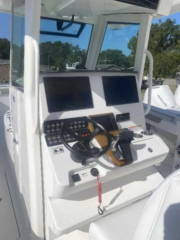 Slide: The Image of 2025 Caymas 34 CT boat cockpit with modern controls and dual screens. - 8