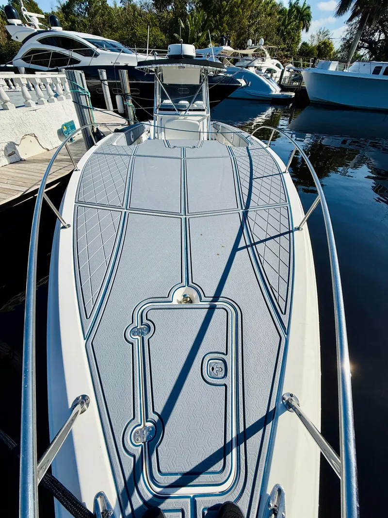 The Image of 2003 Fountain 38 TE boat docked, showcasing spacious deck and sleek design. - 1