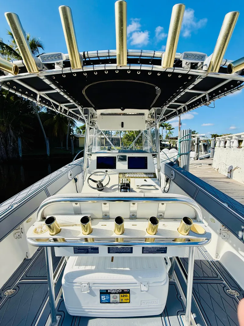 Slide: The Image of 2003 Fountain 38 TE boat with fishing rod holders and navigation equipment. - 13
