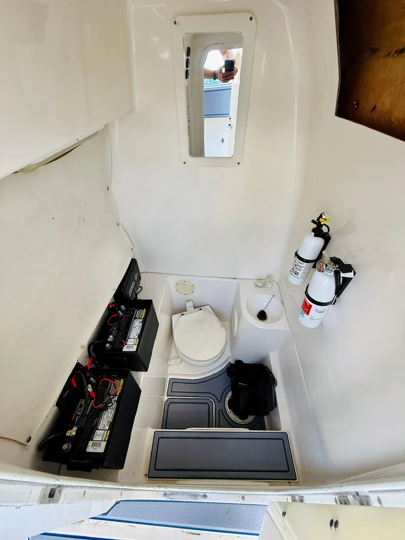 Slide: The Image of 2003 Fountain 38 TE boat interior with toilet, batteries, and fire extinguishers. - 18