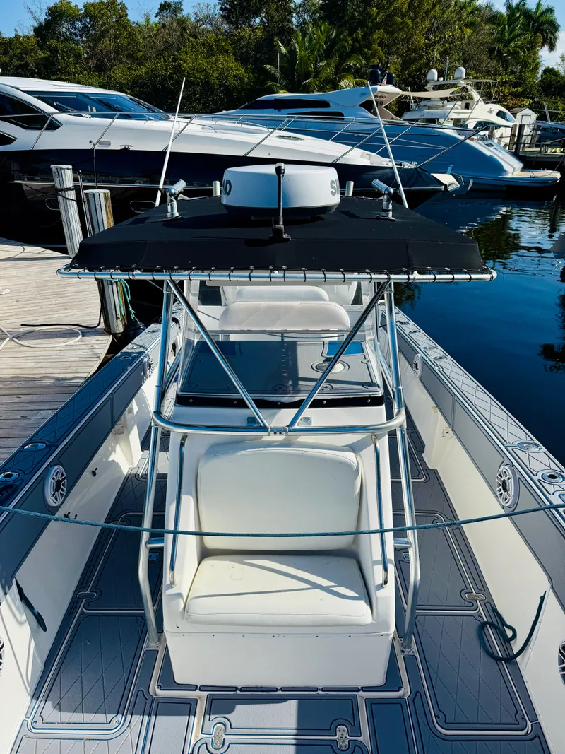 Slide: The Image of 2003 Fountain 38 TE boat docked, featuring a sleek design and spacious seating area. - 4