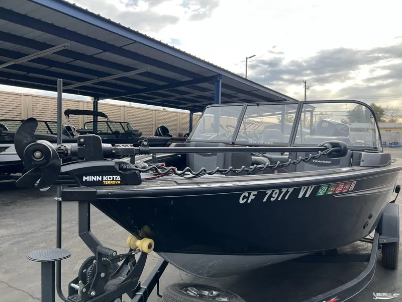 Slide: The Image of 2023 Tracker V-19 boat with Minn Kota Terrova motor in a covered storage area. - 10