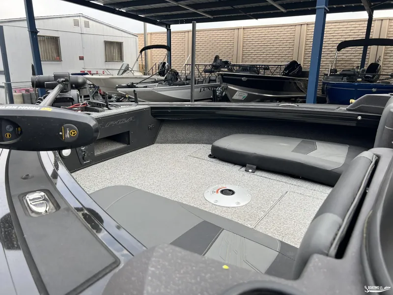 Slide: The Image of 2023 Tracker V-19 boat interior with seating and equipment under a covered area. - 4