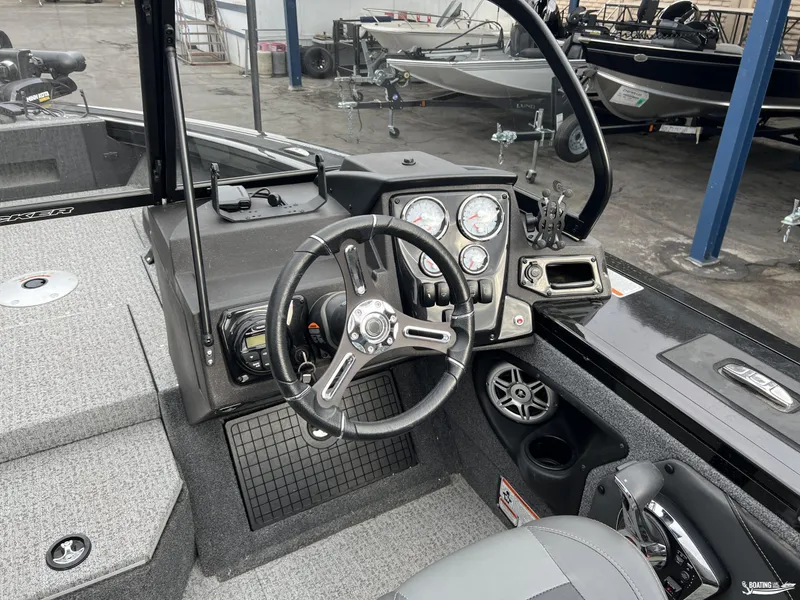 Slide: The Image of 2023 Tracker V-19 boat interior with steering wheel and dashboard controls. - 5