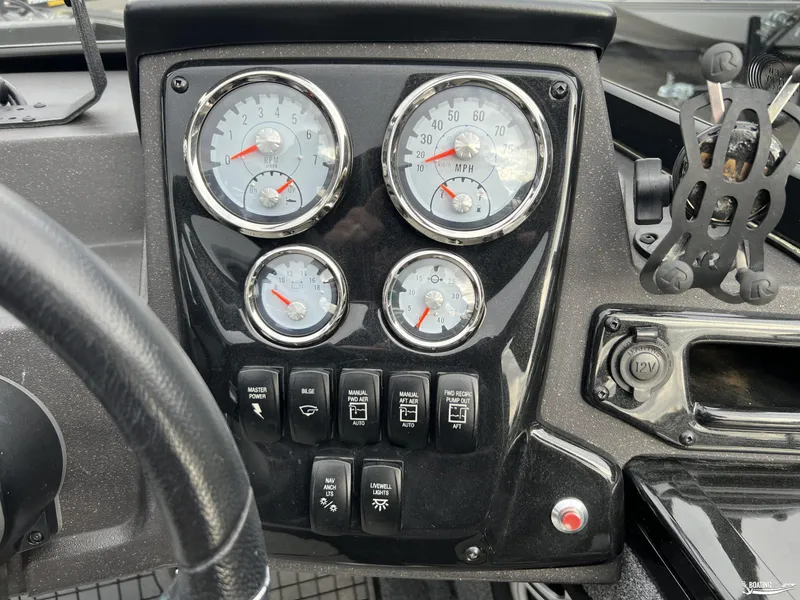 Slide: The Image of Dashboard of 2023 Tracker V-19 boat with gauges and control switches. - 6