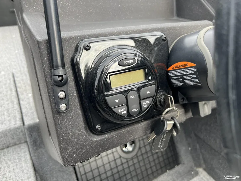 Slide: The Image of Control panel with keys in a 2023 Tracker V-19 boat, featuring power and volume buttons. - 7