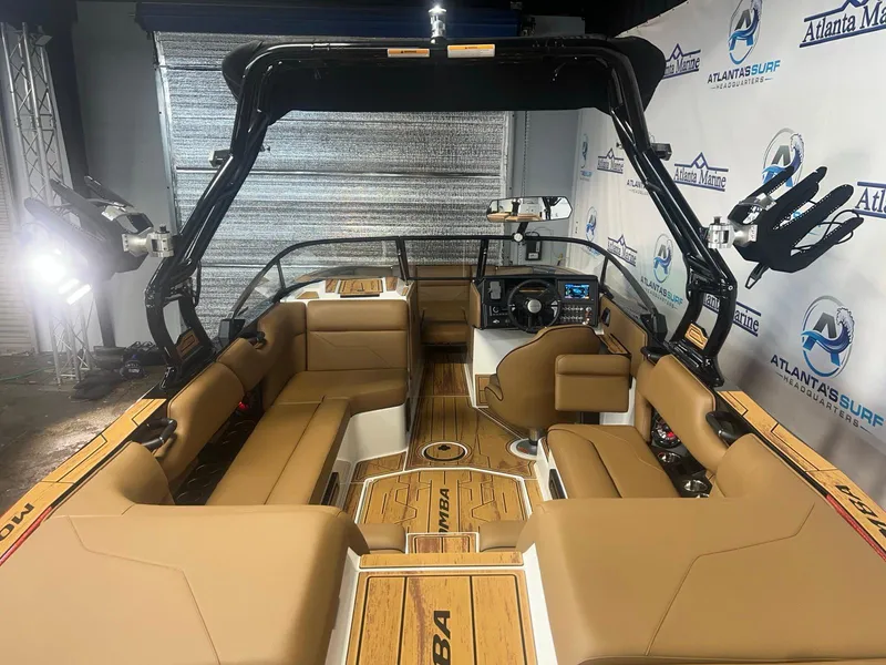 Slide: The Image of 2025 Moomba Max boat interior with tan seating and advanced dashboard features. - 11